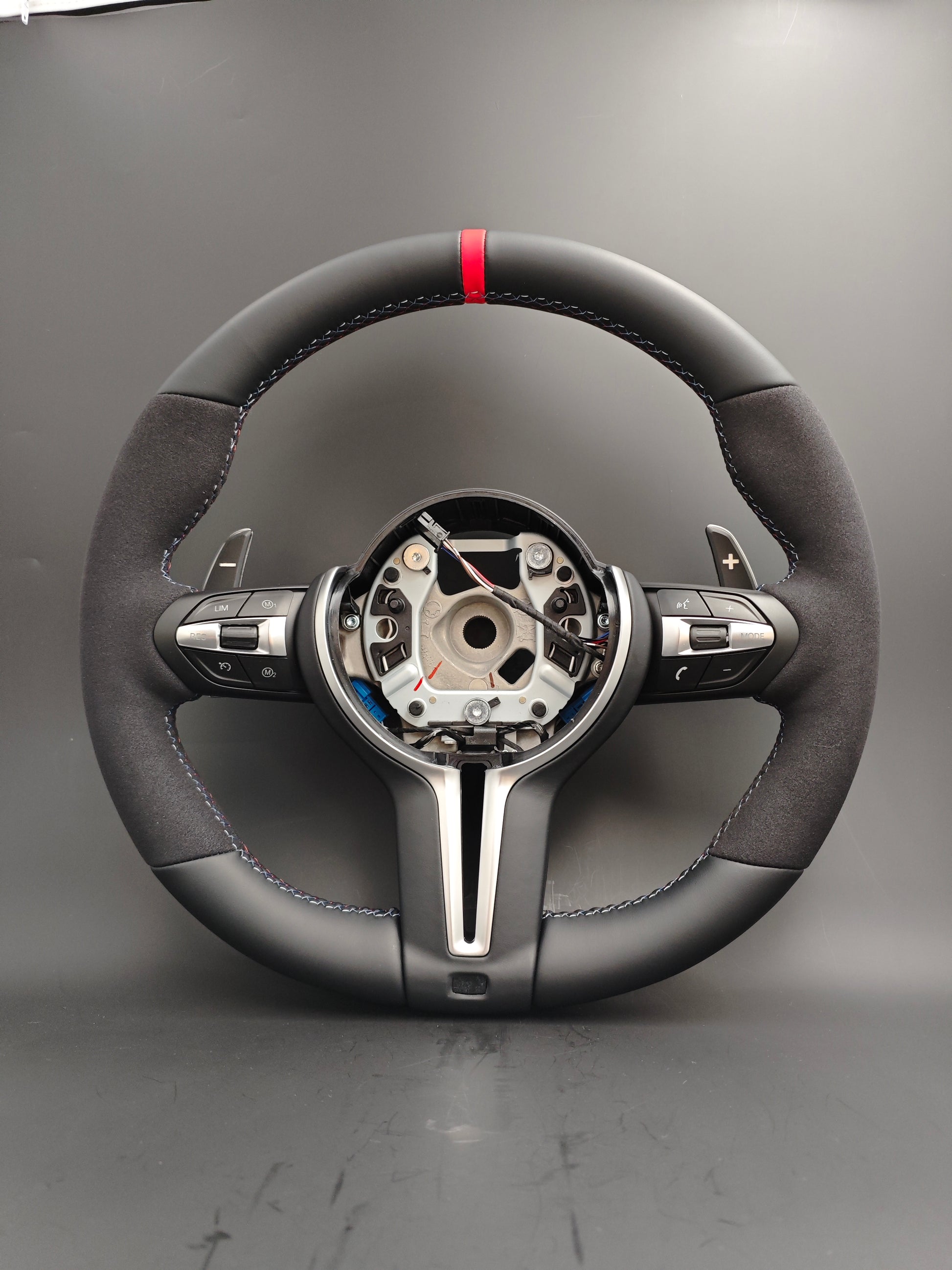 Custom BMW steering wheel upgrade with black leather and suede finish and red center stripe
