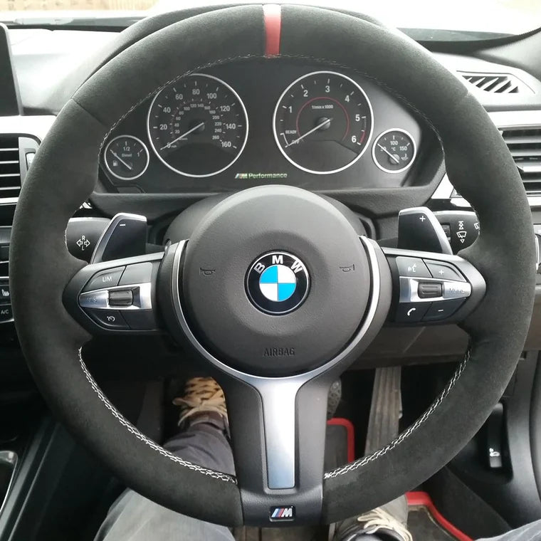 Custom BMW steering wheel upgrade with black suede grip and red center stripe for enhanced performance