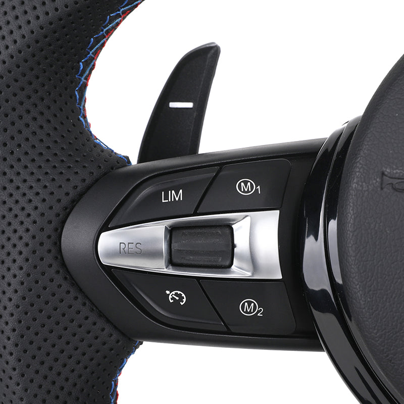 Close-up of custom LED steering wheel for BMW showing control buttons and textured grip