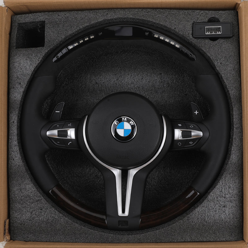 BMW forged carbon steering wheel with leather grip and paddle shifters in protective foam packaging