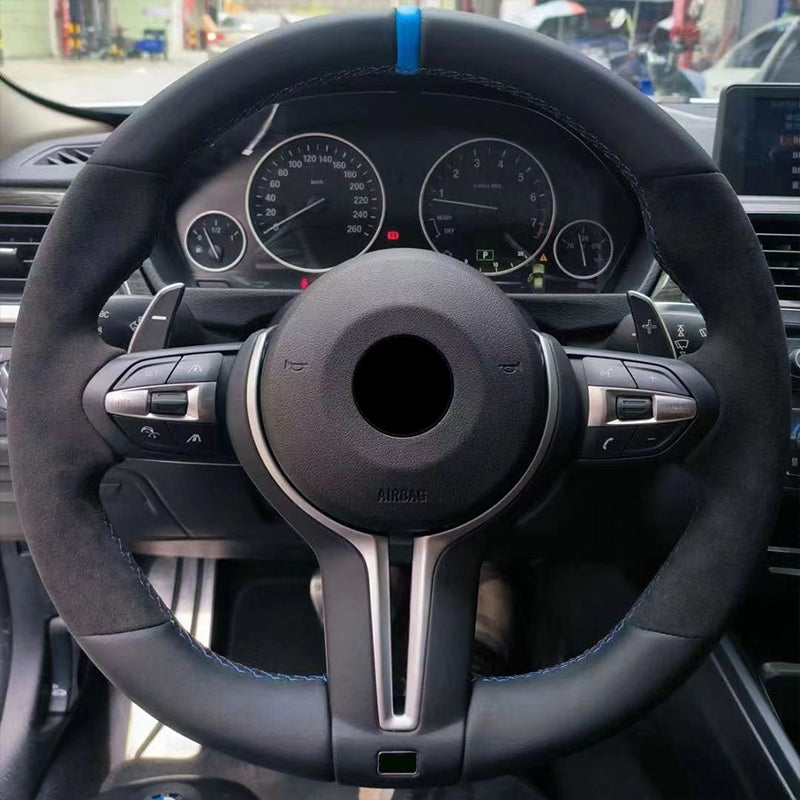 Steering wheel of a car with dashboard instruments visible