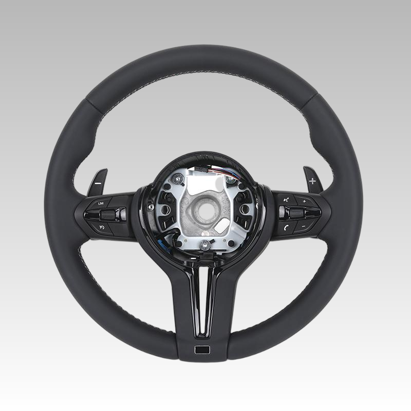 Black steering wheel with silver center on a gray background