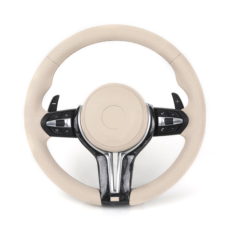 Beige steering wheel with black accents on a white background