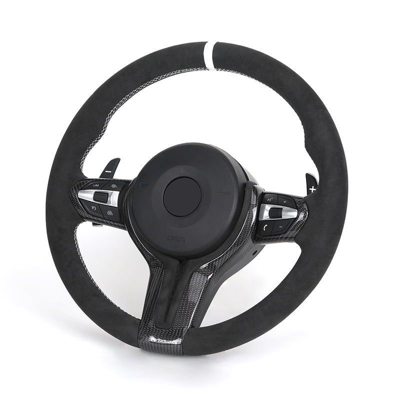 Black steering wheel with carbon fiber accents on a white background