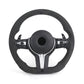 Black steering wheel with silver accents on a white background