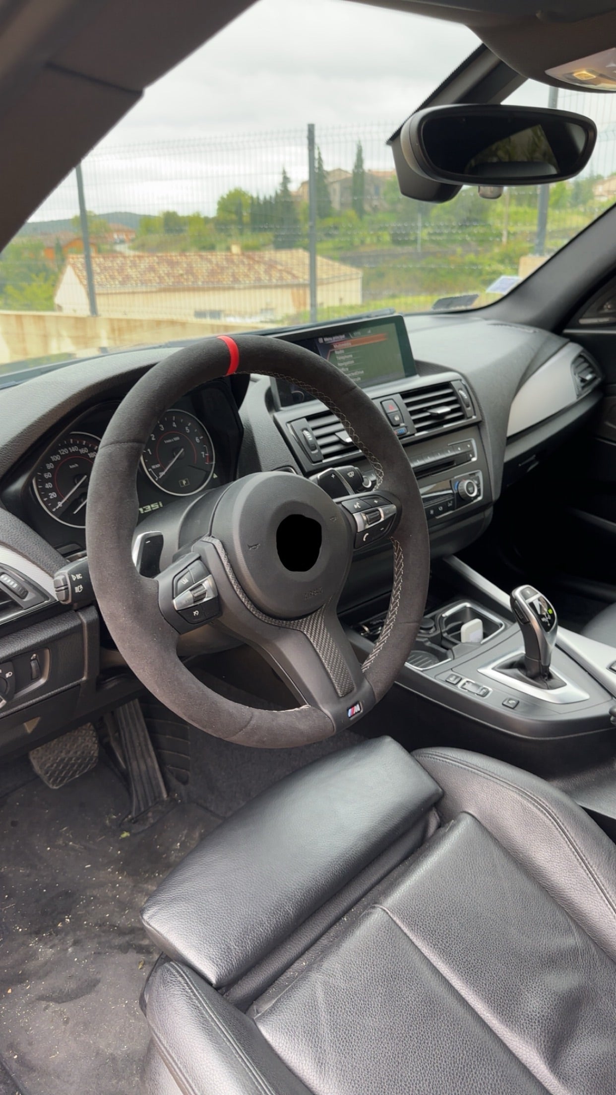 Car interior with steering wheel and dashboard view