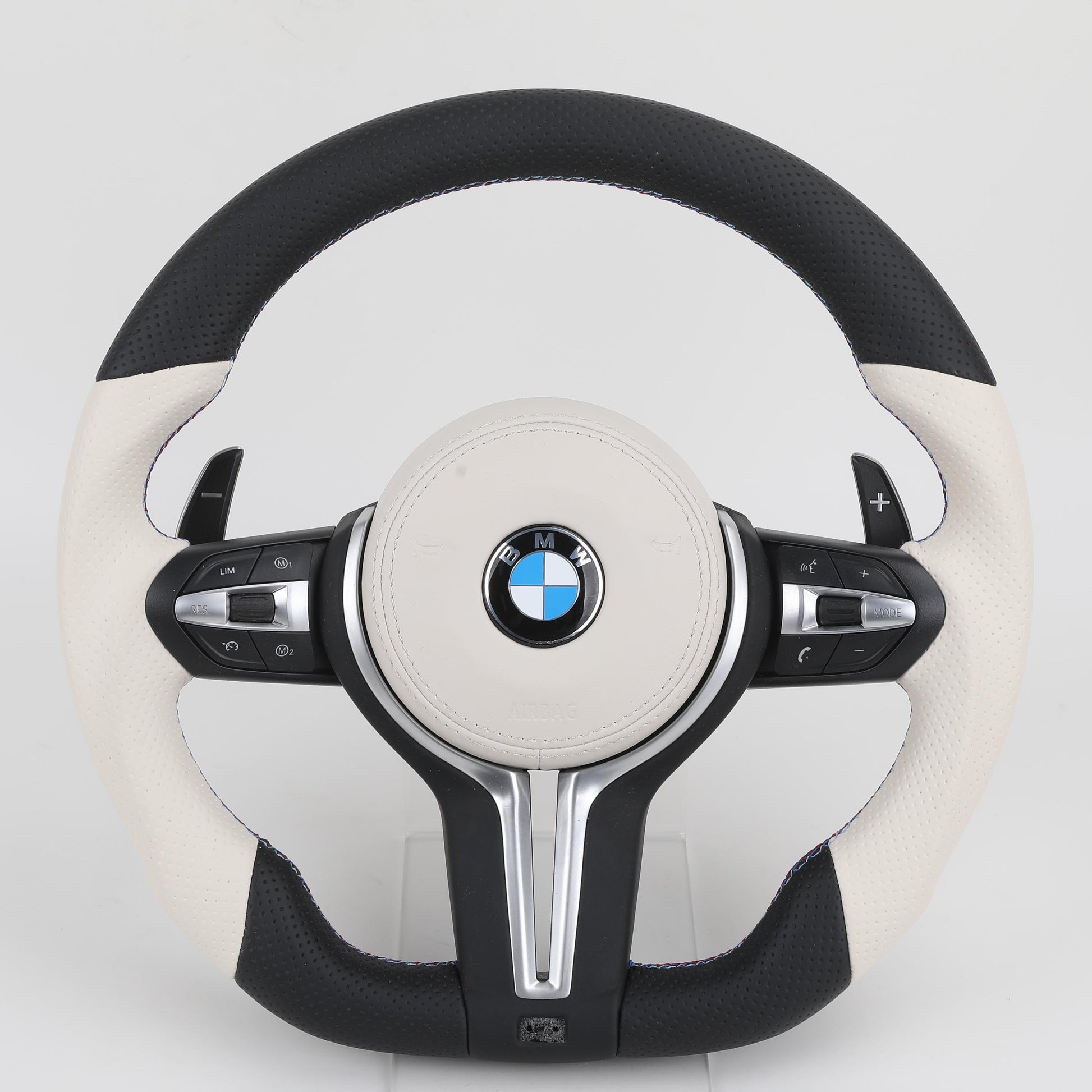 BMW steering wheel with black and white design on a light gray background