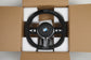 BMW steering wheel in a cardboard box with foam padding