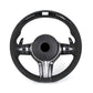 Black steering wheel with silver accents on a white background