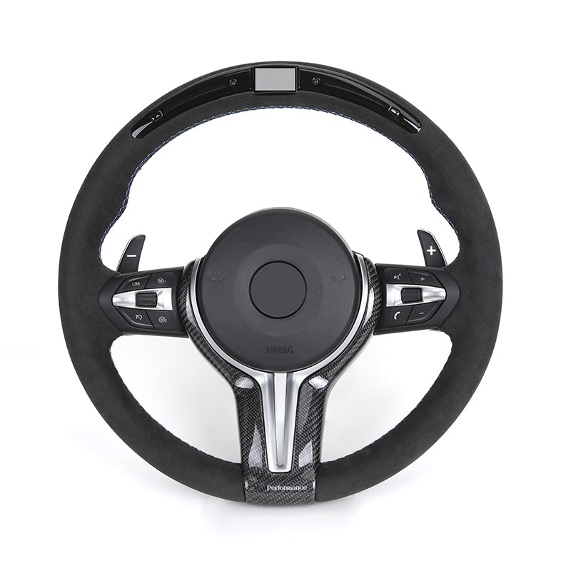 Black steering wheel with carbon fiber accents on a white background