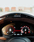 Close-up of a car's instrument cluster with a blurred background
