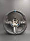 Black custom BMW steering wheel upgrade with blue center stripe and paddle shifters