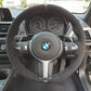 Custom BMW steering wheel upgrade with suede finish and M badge in luxury car interior