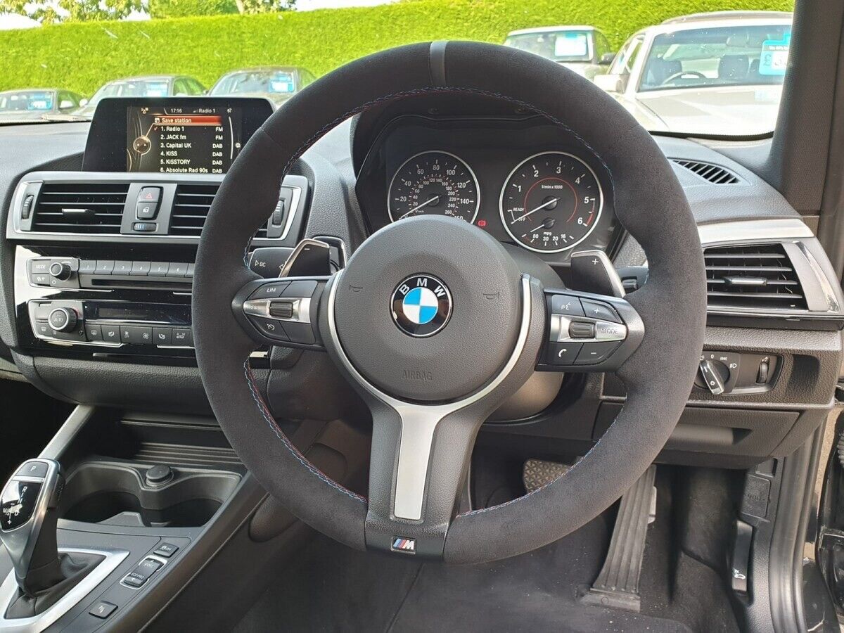 Custom BMW steering wheel upgrade in black suede with multi-function controls inside a BMW car interior