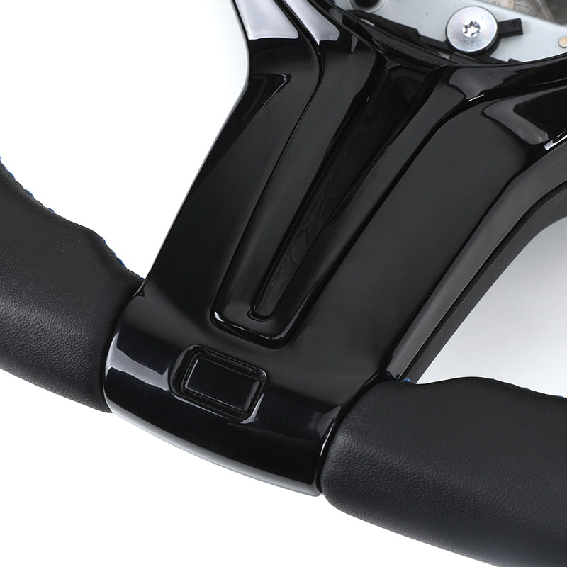 Close-up of custom LED steering wheel for BMW with black leather grip and glossy center panel