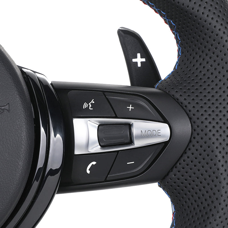 Close-up of custom LED steering wheel for BMW showing control buttons and perforated leather grip