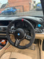 BMW interior featuring a custom M series steering wheel with suede wrap and red center marker