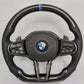 Forged carbon fiber steering wheel BMW with black perforated leather grips and M stripe detail