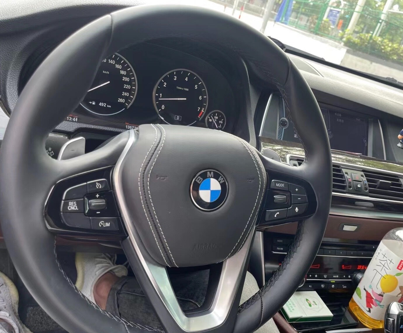 BMW car interior showing the forged carbon fiber steering wheel BMW with control buttons and dashboard