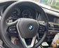 BMW car interior showing the forged carbon fiber steering wheel BMW with control buttons and dashboard