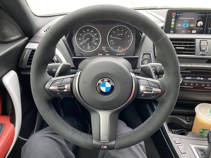 BMW forged carbon steering wheel inside a BMW car with dashboard and controls visible