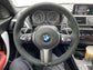 BMW forged carbon steering wheel inside a BMW car with dashboard and controls visible