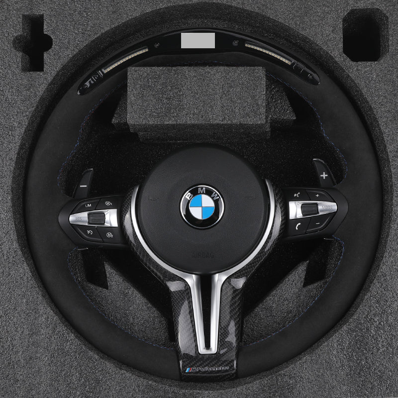 BMW forged carbon steering wheel with control buttons and BMW logo in protective foam packaging