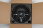 LED BMW steering wheel upgrade in black leather with red stitching and BMW logo in packaging