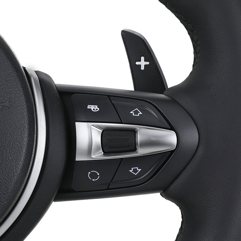 Close-up of BMW LED steering wheel upgrade control buttons and paddle shifter in black and silver