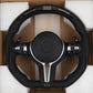 BMW M series carbon steering wheel with perforated leather and integrated control buttons in protective packaging