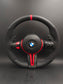 BMW performance steering wheel replacement with black and red design featuring control buttons and carbon fiber accents