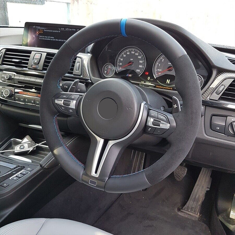 BMW luxury car carbon steering wheel replacement with black suede and blue accent stitching in sporty interior